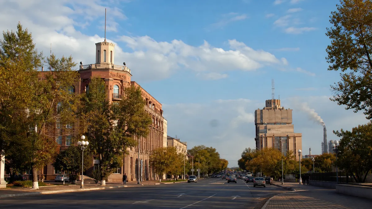 Conceptual contemporary Karaganda boulevard with civic architecture, trees and a broad Central Kazakhstan sky