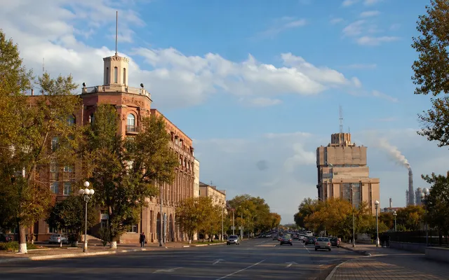 Conceptual contemporary Karaganda boulevard with civic architecture, trees and a broad Central Kazakhstan sky