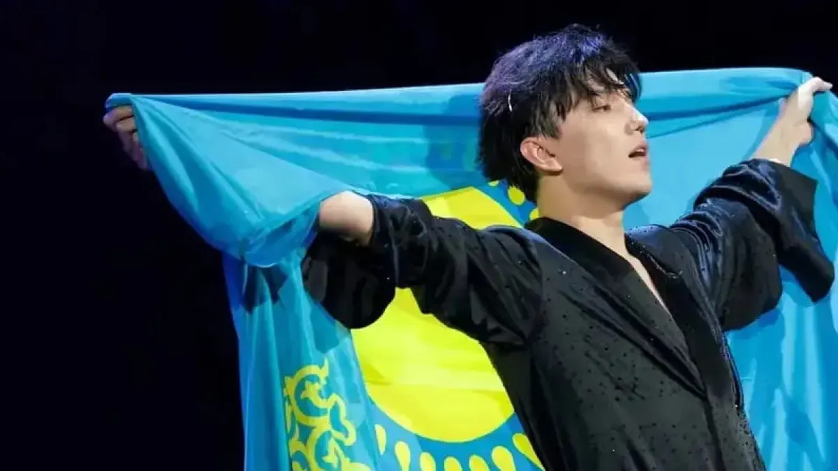 Dimash Kudaibergen performing on stage with dramatic lighting during a concert