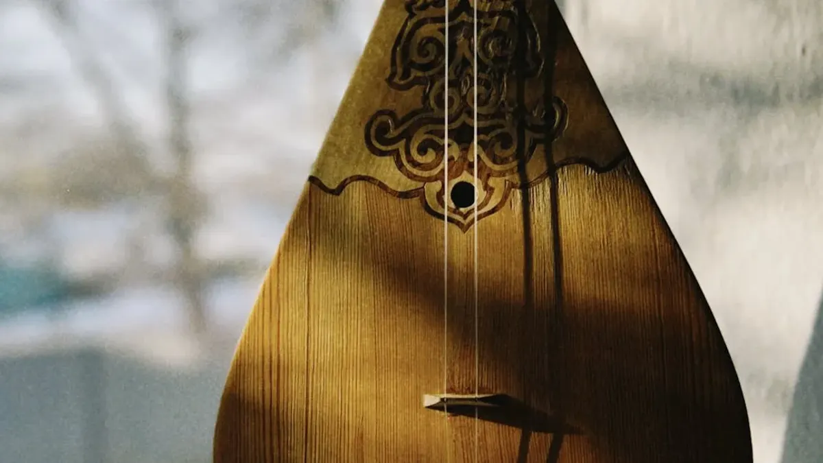 Traditional Kazakh dombra with ornamental carving displayed by a window in natural light