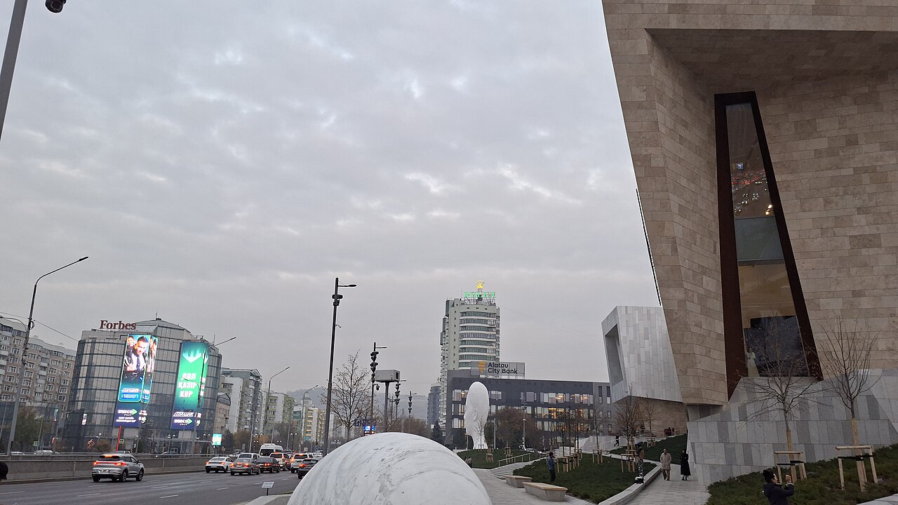 Modern cityscape of Almaty with mountains in the background
