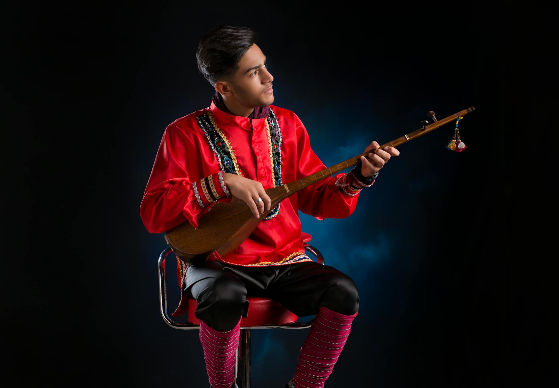 Traditional Kazakh dombra two-stringed instrument being played by a musician