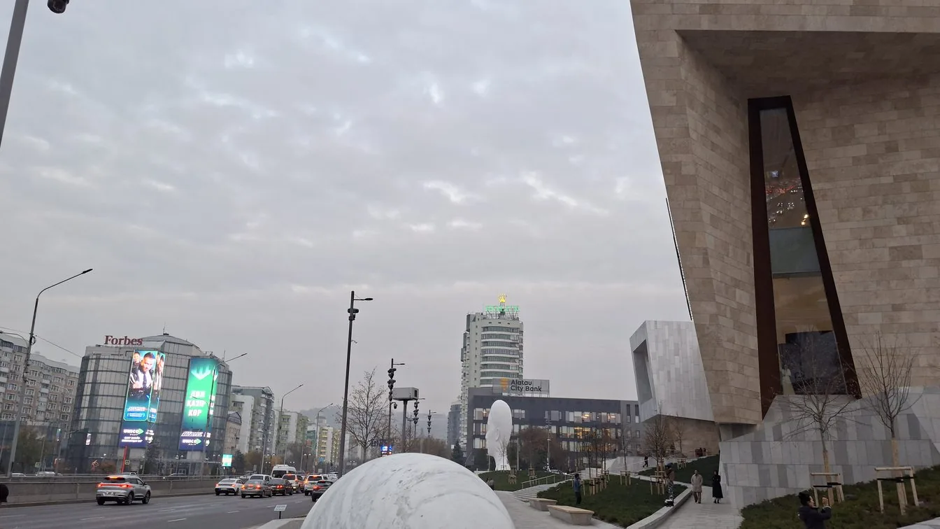 Modern cityscape of Almaty with mountains in the background