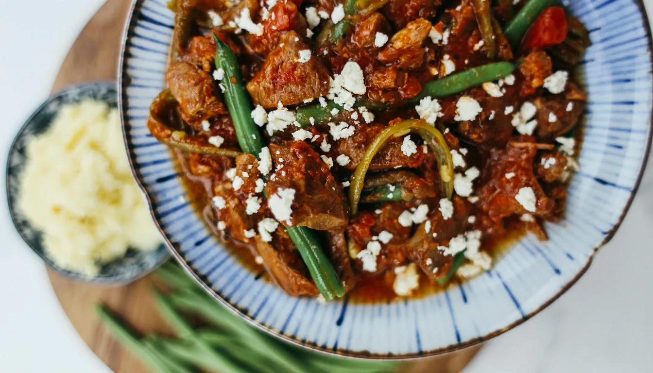 Spread of traditional Kazakh dishes including beshbarmak, baursaki, and tea on a dastarkhan
