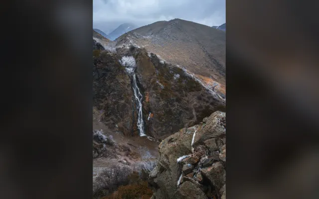 Bear Falls in Turgen Gorge with snow on the surrounding slopes