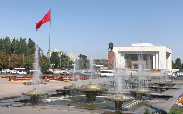 Fountains, an equestrian monument and the national flag at Bishkek's Ala-Too Square in August 2021