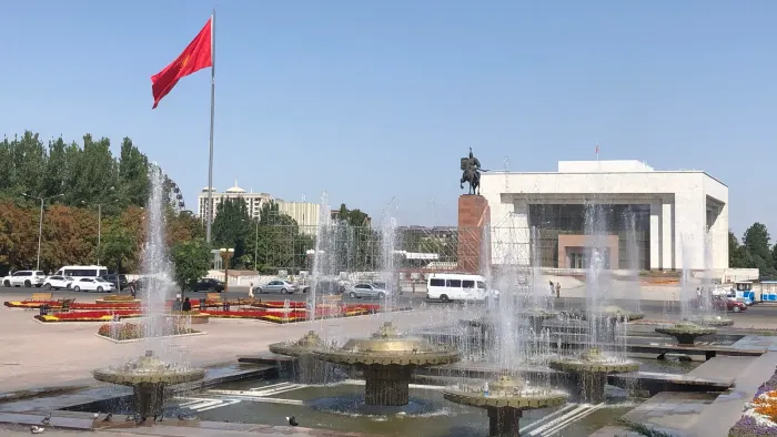 Fountains, an equestrian monument and the national flag at Bishkek's Ala-Too Square in August 2021