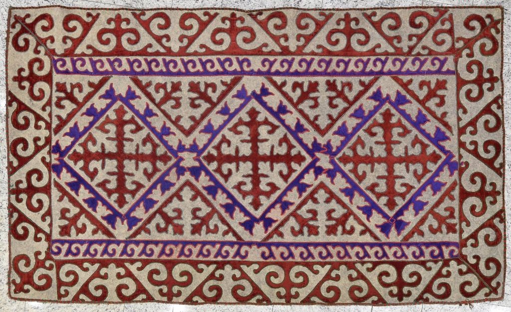 A traditional Syrmak, a handcrafted Kazakhstan rug with intricate patterns and vibrant colors.