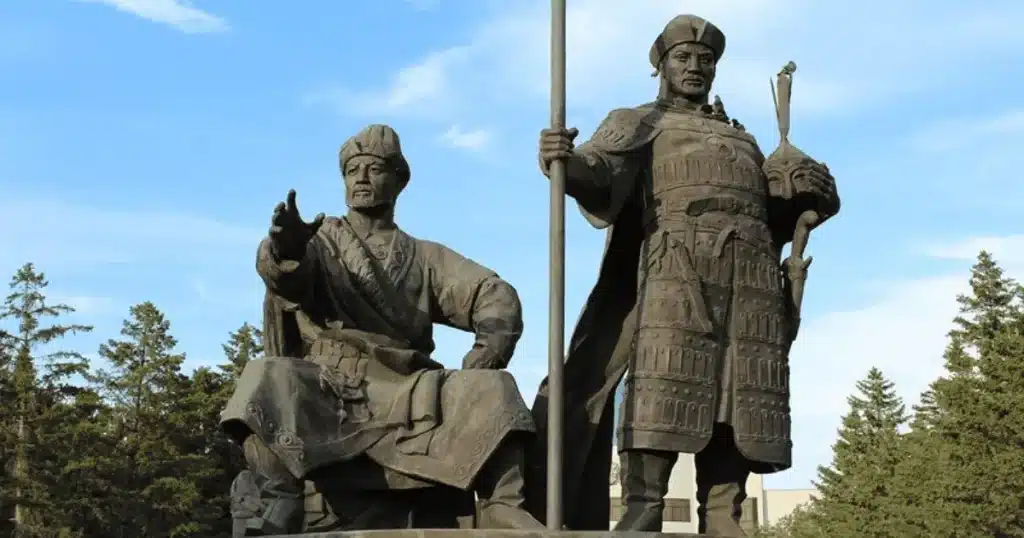 Monument of Janibek and Kerey, the founders of the Kazakh Khanate, standing proudly in traditional attire. Janibek is depicted seated, gesturing forward, while Kerey stands beside him holding a staff, symbolizing leadership and unity. This statue commemorates their pivotal role in establishing the Kazakh Khanate in the 15th century.